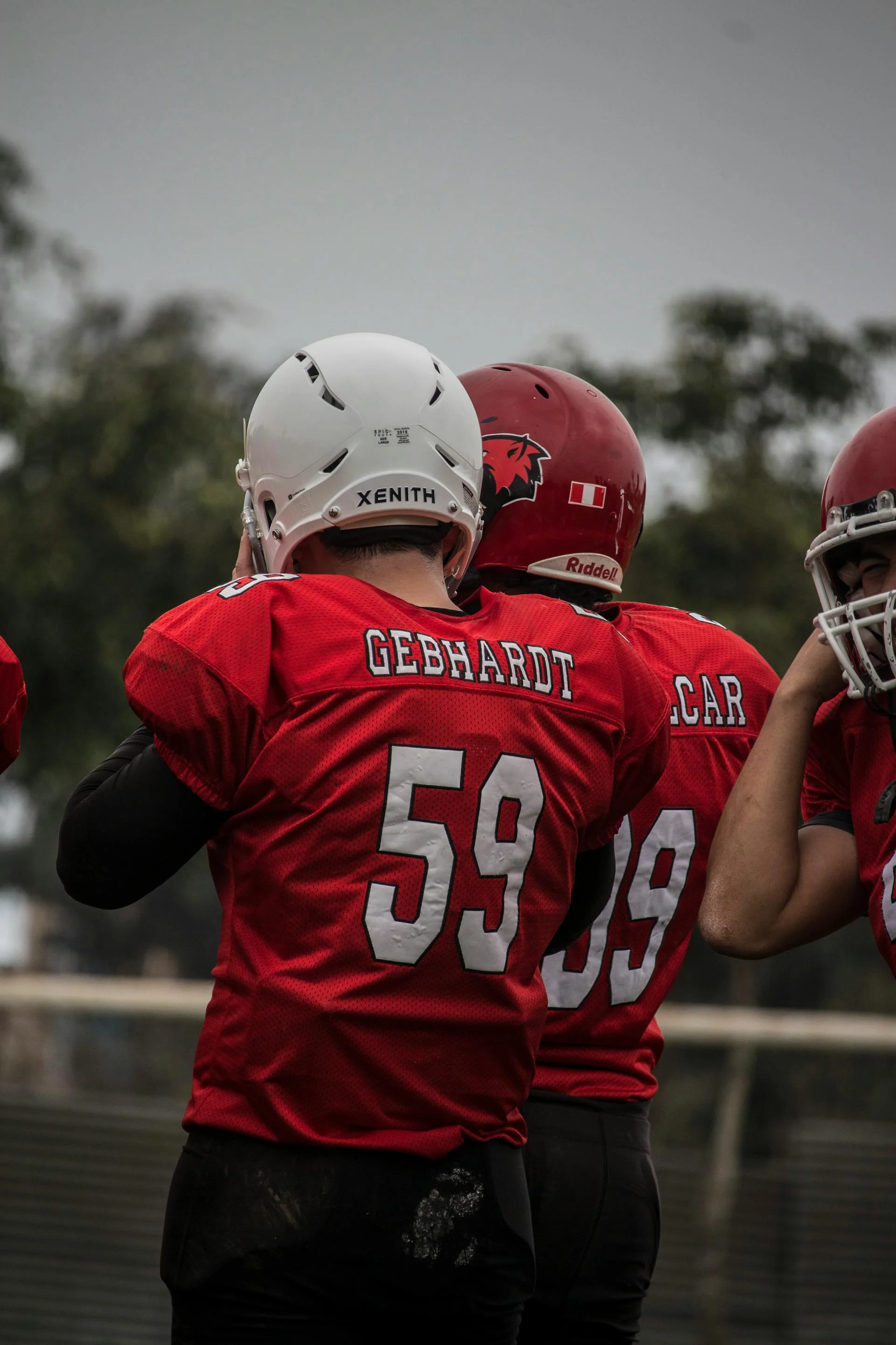 Custom high school football jersey with player name and number in school colors